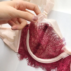 Detail of thin mesh cups with burgundy eyelash lace overlay and supportive underwire