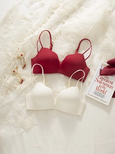 Deep red and off-white seamless wireless bras displayed with elegant lace and pearls