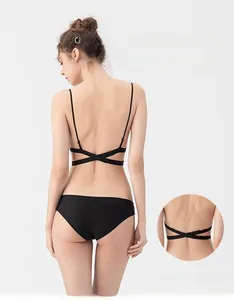 Detail showing back view of black U-back bra with thin cross straps and single-row buckle