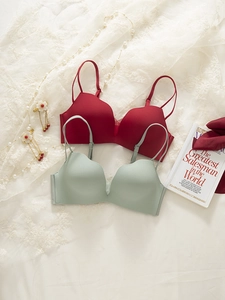 Close-up of seamless wireless bras in red and green with elegant wavy edge details