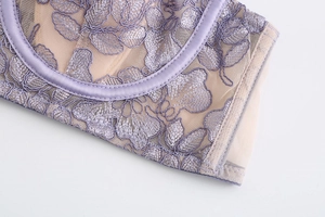 Close-up of French lavender lace embroidery and delicate mesh detail on the bra