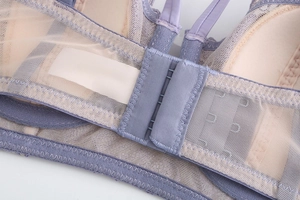 Detail of purple lace bra featuring three-row hook closure and breathable mesh wings