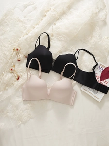Detail of seamless wireless bras in black and beige with smooth fabric and lace