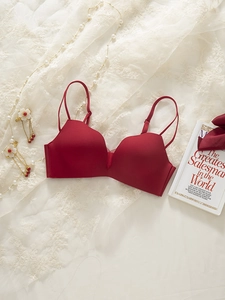 Detail of dark red seamless bra with adjustable double straps on elegant lace background