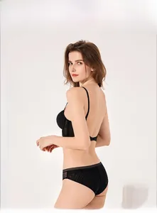 Macro shot of seamless black U-shaped open back bra and matching lace underwear set