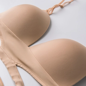 Detail view of seamless beige French bra with smooth wireless triangle cups and thin straps