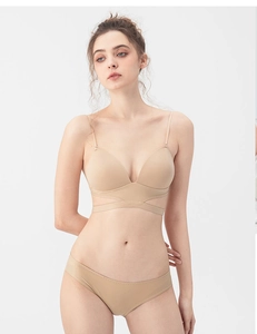 Detail of seamless beige backless bra set with thin straps and cross-strap design