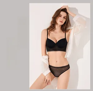 Detailed view of seamless black U-back bra with striped lace band and matching panties