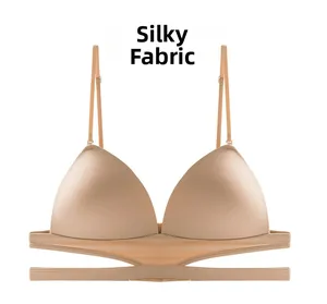 Detail of silky skin-tone wireless bra with seamless triangle cups and cross-cut band