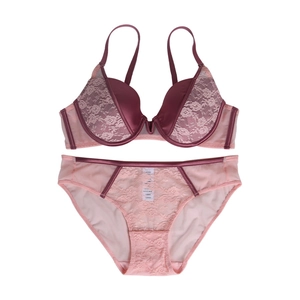Flat lay of french lace lingerie set with silk details and floral embroidery textures