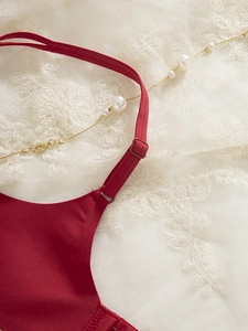 Detailed macro view of the seamless burgundy bra featuring silky fabric and adjustable straps