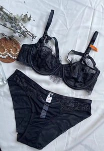 Detail of black eyelash lace bra set with strappy design and sheer mesh fabric