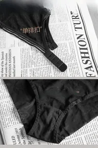 Detail of black lace lingerie with single-row buckle closure and soft cotton crotch lining