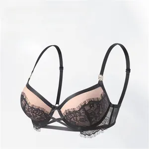 Detail showing black eyelash lace overlay on nude cups with elegant cross-strap design