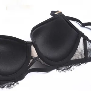 Detail view of the 1.5cm push-up molded cup and delicate lace trim on this black bra