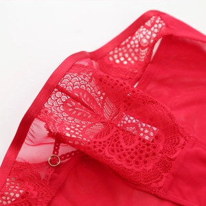 Détail de dentelle florale rouge et lingerie en résille avec anneau doré chic