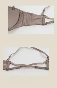 Detail of pink seamless bra featuring side wings and criss-cross back strap design