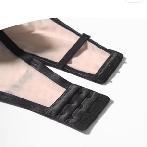 Detail of three-row hook-and-eye closure on lace push-up bra with mesh texture