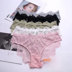 Flat lay of multiple lace panties in grey, black, and white with floral embroidery