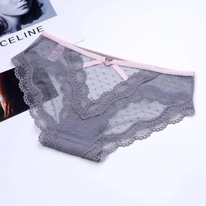 Detail of sheer mesh lace panties featuring a heart-shaped metal buckle and low-rise design