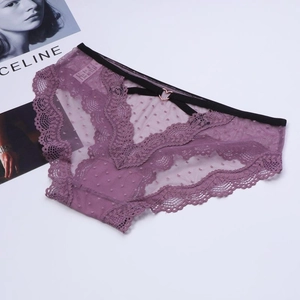 Detail of purple lace underwear featuring polka dot mesh and rose gold heart buckle