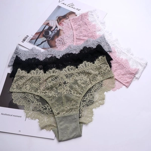 Macro shot of five lace panties with floral embroidery and delicate eyelash trim edges