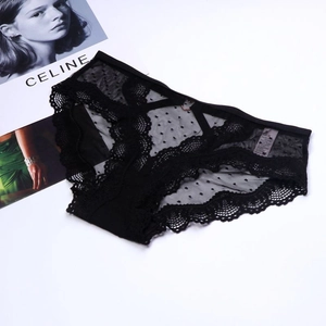 Detailed view of black lace panties with heart metal buckle and sheer mesh design