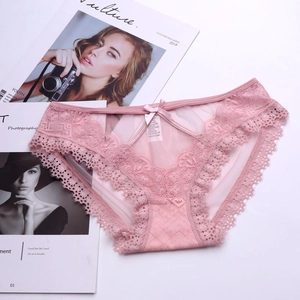 Detailed macro of pale pink floral lace panties with silk bow and V-shaped cutout detail