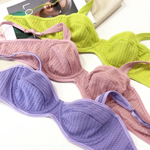 Detail of ultra-thin mesh bras in green, pink and purple with waffle texture and underwire