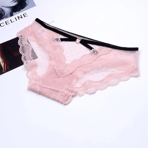 Detailed view of pink lace and polka dot mesh with rose gold heart-shaped metal buckle
