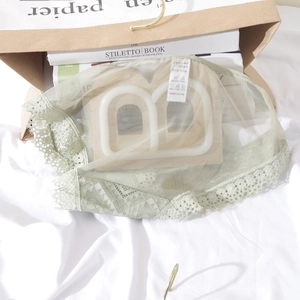 Detailed view of light green lace panties with mesh fabric and soft cotton crotch
