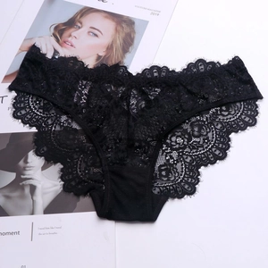 Close-up of black floral lace panties with eyelash lace trim on a fashion magazine