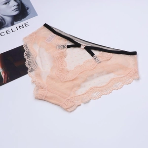 Close-up of peach mesh panties with heart-shaped metal buckle and lace details
