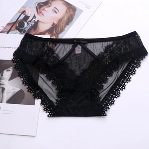 Detailed view of black lace mesh panties with eyelash trim and satin bow detail