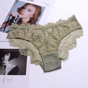 Detail of olive green lace panties with delicate floral patterns and mesh texture
