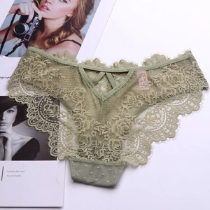 Detailed close-up of olive green lace panties with floral patterns and V-shaped cutout back