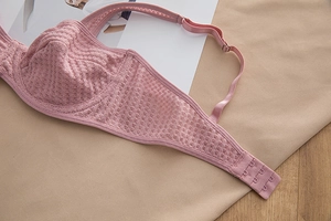 Detail of breathable lace mesh bra in lotus pink with adjustable straps and hook closure
