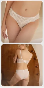 Detailed view of white lace lingerie set featuring intricate floral embroidery and mesh