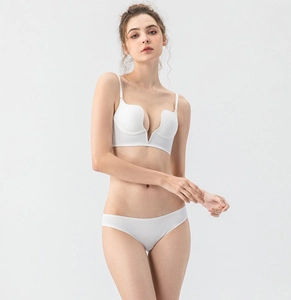 Deep V seamless white lingerie set with plunge bra and matching panties on model