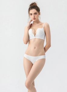 Detail of white deep V seamless bra and panty set with metal connector and thin straps
