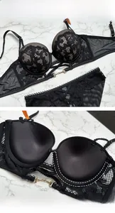 Detail of black lace bra set showing push-up cups and elegant gold metal buckle