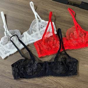 Flat lay of sheer floral lace embroidery bras in white, red and black with wire support