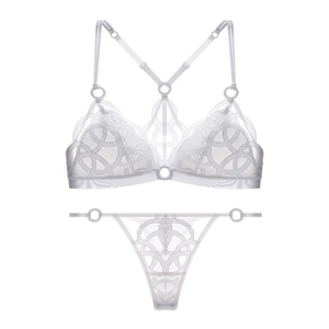 Detail view of white mesh lace lingerie set with geometric embroidery and O-ring hardware