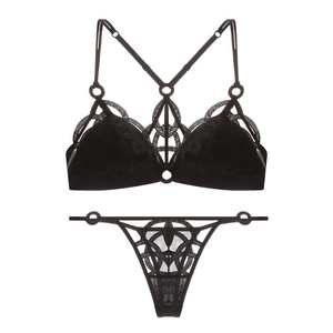 Detail of black lace lingerie set with mesh embroidery and metallic ring connectors