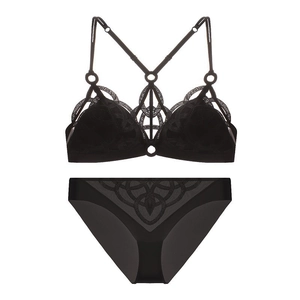 Detailed flat lay of black mesh lingerie set with geometric embroidery and strappy details