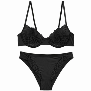 Detailed view of black lace lingerie set with floral embroidery and satin finish