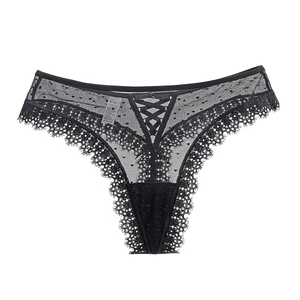 String en dentelle avec détails croisés et bordure en dentelle sur fond blanc