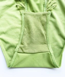 Close-up of grass green underwear featuring double-layer cotton crotch and lace details