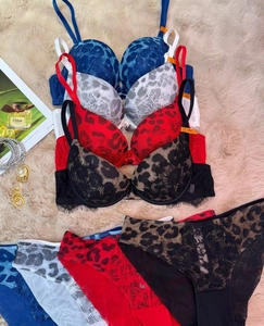 Detailed flat lay of lace leopard print bra sets in blue, gray, red, and black colors