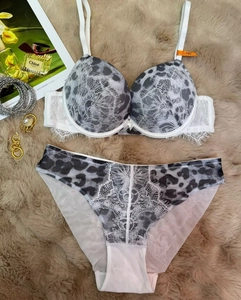 Detailed flat lay of leopard print lace bra and panty set with 75C size tag on fur
